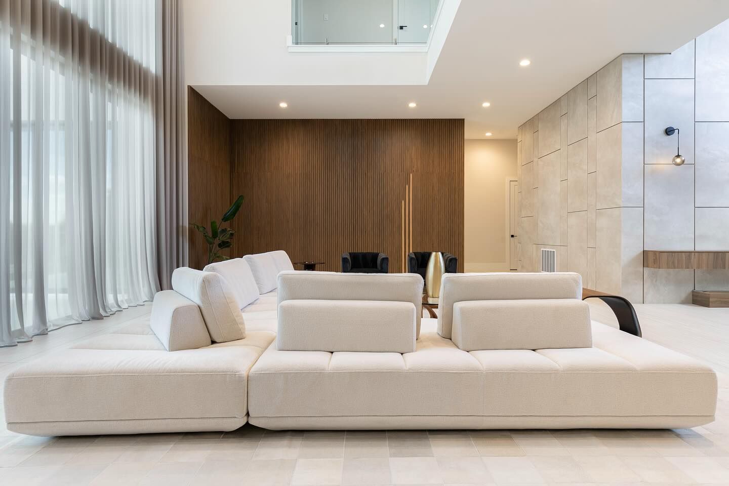 Living room with a full-height walnut feature wall