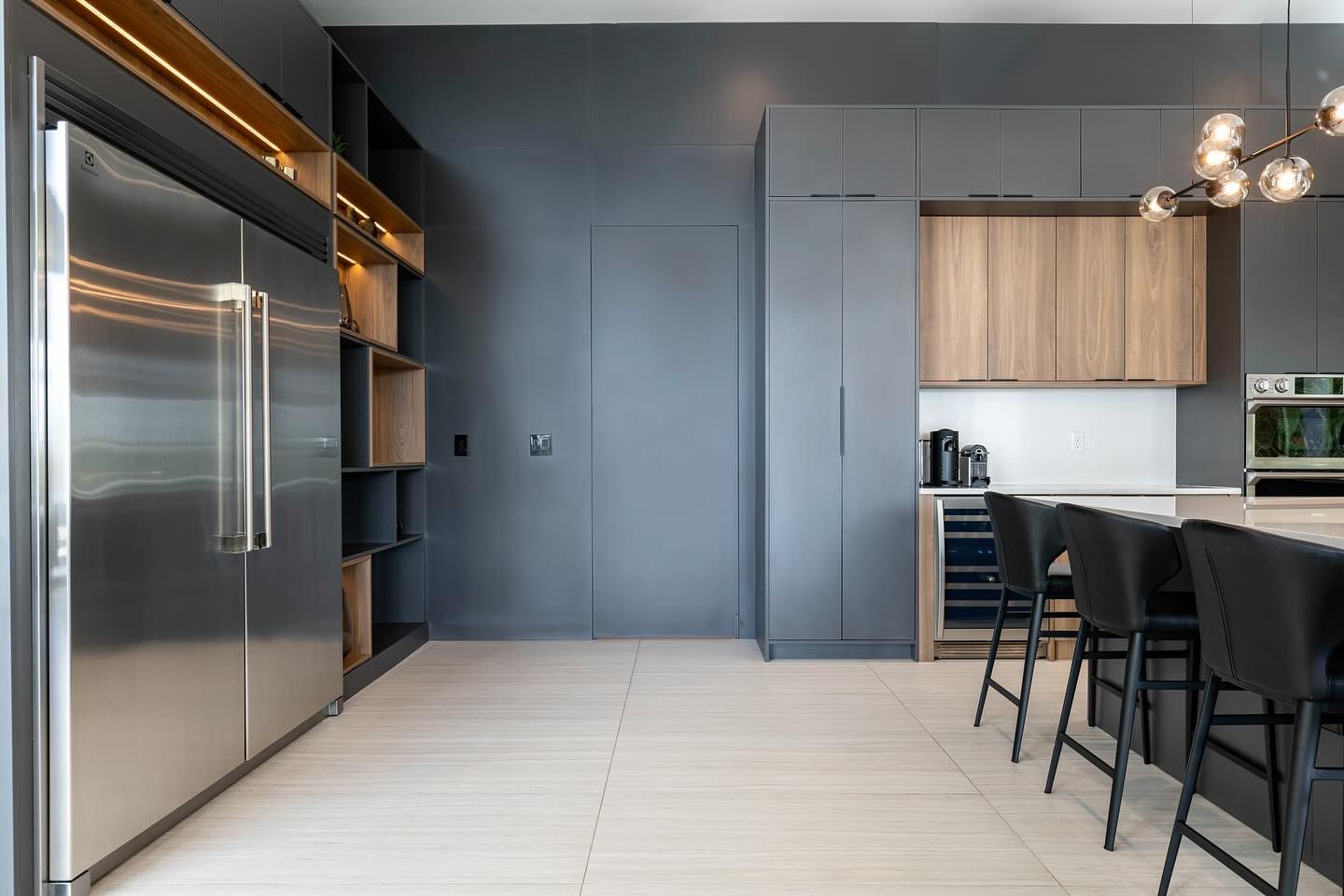 Kitchen with charcoal cabinets and a wood-trimmed built-in