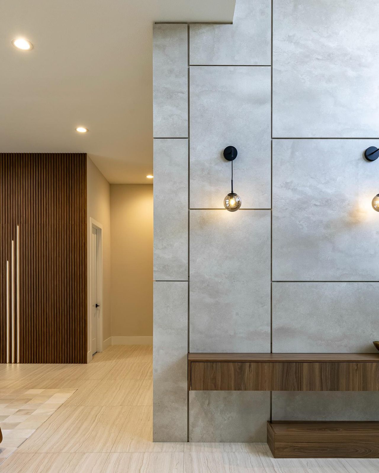 Hallway with wood panel and floating wood shelf
