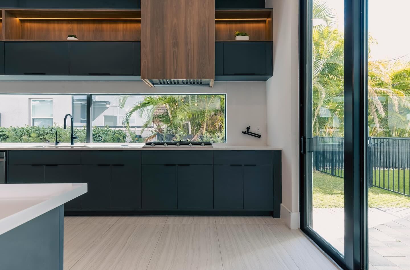 Kitchen sink cabinets under a garden-view window