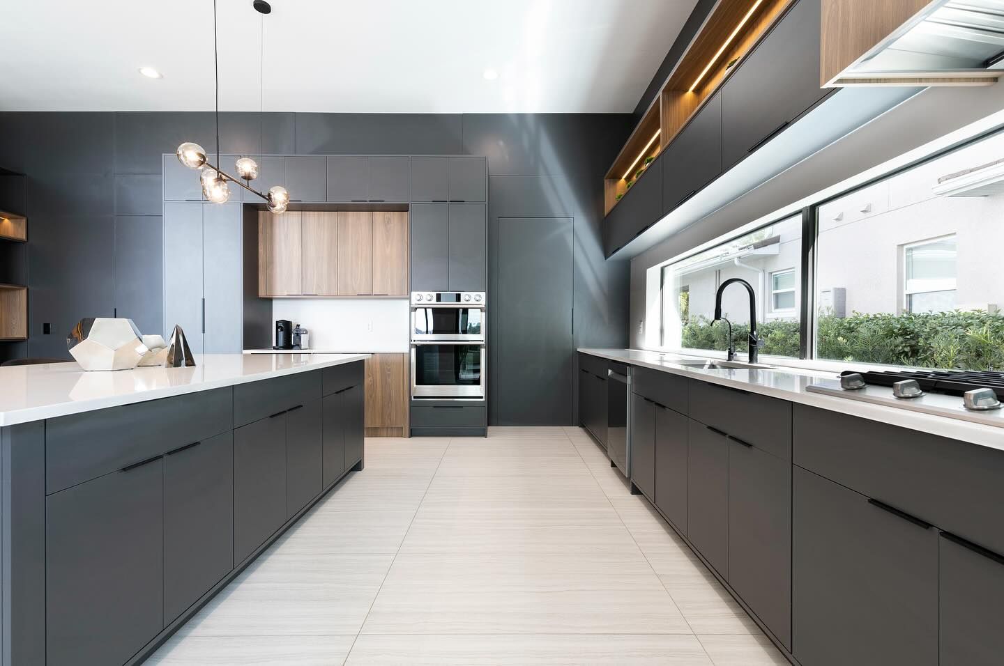 Modern kitchen with dark cabinets and pendant lights